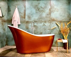 A luxurious freestanding tub in a stylish setting, showcased in Greer Tiling's Bathroom Showroom, featuring elegant tile designs.