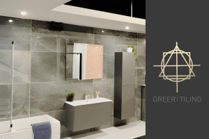 Greer Tiling's Bathroom Showroom - a staged bathroom featuring large, grey tiles and light grey fixtures.